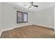 Spacious bedroom featuring two windows, wood floors and neutral paint at 2869 Josephine Dr, Henderson, NV 89044