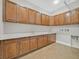 Large laundry room features wood cabinets, quartz countertop and tile floors at 2869 Josephine Dr, Henderson, NV 89044