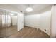 Spacious bedroom with modern light fixture, hard floors, and mirrored closet at 3038 Tarpon Dr # 102, Las Vegas, NV 89120