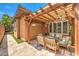 An inviting outdoor dining area with a pergola, providing a cozy spot for meals at 409 Lake Windemere St, Las Vegas, NV 89138