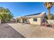 Spacious backyard showcasing rock landscaping and covered patio with solar panels at 427 Mindoro Ave, North Las Vegas, NV 89031
