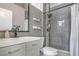 Stylish bathroom featuring gray tile, modern fixtures, and a shower with rainfall head at 427 Mindoro Ave, North Las Vegas, NV 89031