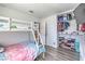 Bedroom featuring a bunk bed, laminate floors, natural light and closet with organizers at 427 Mindoro Ave, North Las Vegas, NV 89031