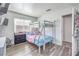 Bedroom featuring a bunk bed, laminate floors, natural light, and a TV at 427 Mindoro Ave, North Las Vegas, NV 89031