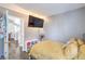 Neutral bedroom with laminate floors, natural light, and a TV at 427 Mindoro Ave, North Las Vegas, NV 89031