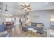 Open-concept living area with hardwood floors, comfortable seating, and views into the dining area at 427 Mindoro Ave, North Las Vegas, NV 89031