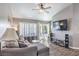 Comfortable living room featuring a modern ceiling fan, plush sectional, and hardwood floors at 427 Mindoro Ave, North Las Vegas, NV 89031