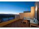 Relax on the balcony with comfortable seating and city views at dusk at 438 Serenity Point Dr, Henderson, NV 89012