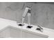 Close-up of a modern bathroom faucet with running water and marble backsplash at 438 Serenity Point Dr, Henderson, NV 89012