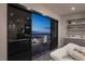 Modern bedroom featuring sliding glass doors opening to a balcony with city views at 438 Serenity Point Dr, Henderson, NV 89012
