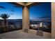 Covered patio with a stunning view of the Las Vegas skyline at night at 438 Serenity Point Dr, Henderson, NV 89012