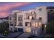 Modern home shows multi-level balconies, contemporary design, and a sleek garage door at 438 Serenity Point Dr, Henderson, NV 89012