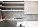 Close up of the modern kitchen shows the sleek countertops, gas stovetop, and floating shelves at 438 Serenity Point Dr, Henderson, NV 89012