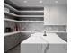 Bright kitchen with quartz countertops, stainless steel appliances, and open shelving at 438 Serenity Point Dr, Henderson, NV 89012