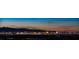 Panoramic view of the Las Vegas Strip at night, showcasing illuminated hotels and desert mountains at 438 Serenity Point Dr, Henderson, NV 89012
