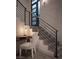 Modern staircase with metal railing ascends past a desk nook near a window, creating a stylish transition between levels at 438 Serenity Point Dr, Henderson, NV 89012
