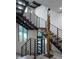 Modern staircase with wooden sculpture and view of the outdoors at 438 Serenity Point Dr, Henderson, NV 89012