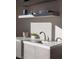 A contemporary wet bar features sleek cabinetry, floating shelves, and a modern faucet at 438 Serenity Point Dr, Henderson, NV 89012