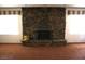 Living room boasting a large stone fireplace and large bright windows at 4536 E Baltimore Ave, Las Vegas, NV 89104