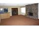 Spacious living room with a stone fireplace, dry bar and views to another room of the house at 4536 E Baltimore Ave, Las Vegas, NV 89104