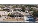 Aerial view of a single-Gathering home with a desert landscape, multiple car garage, and in-ground pool at 4690 Designer Way, Las Vegas, NV 89129