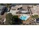 Aerial view of a home featuring a lagoon pool, covered patio, and well-maintained landscaping at 4690 Designer Way, Las Vegas, NV 89129