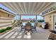 Inviting covered patio with outdoor dining, barbecue, and a view of the sparkling swimming pool at 4690 Designer Way, Las Vegas, NV 89129