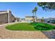 Lush backyard with artificial turf, a sparkling pool, and well-manicured landscaping at 4690 Designer Way, Las Vegas, NV 89129
