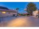 Spacious backyard featuring a basketball court, mature trees, and ample space for entertaining at 4690 Designer Way, Las Vegas, NV 89129