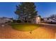 Expansive backyard with lush lawn, mature trees, and gravel beds at 4690 Designer Way, Las Vegas, NV 89129