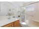 Well-lit bathroom featuring a glass-enclosed shower and marble countertop vanity at 4690 Designer Way, Las Vegas, NV 89129