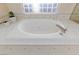 Bright bathroom with a large soaking tub with tile surround, and a plant adds natural touch at 4690 Designer Way, Las Vegas, NV 89129
