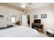 Bright bedroom featuring a ceiling fan, mirrored closet doors, and neutral paint at 4690 Designer Way, Las Vegas, NV 89129