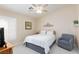 Well-lit bedroom with carpet, fan, window and relaxing decor at 4690 Designer Way, Las Vegas, NV 89129