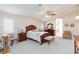 Spacious primary bedroom with bright natural light, ceiling fan, and neutral carpeting at 4690 Designer Way, Las Vegas, NV 89129