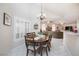 Cozy breakfast nook with a view of the living room with dining table and seating at 4690 Designer Way, Las Vegas, NV 89129