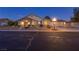 Inviting single-Gathering home featuring a well-manicured lawn, mature trees, and a two-car garage at 4690 Designer Way, Las Vegas, NV 89129