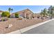 Charming single-story home featuring a desert landscape, covered entrance and well-maintained lawn at 4690 Designer Way, Las Vegas, NV 89129