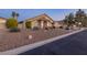Attractive one-story home featuring desert landscaping, arched windows, and a well-maintained lawn at 4690 Designer Way, Las Vegas, NV 89129