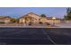 Charming single-story home featuring a 3 car garage, desert landscape, and well-lit driveway at 4690 Designer Way, Las Vegas, NV 89129