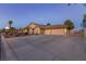 Desirable property with a spacious driveway, 3 car garage, beautiful lawn, and desert landscaping at 4690 Designer Way, Las Vegas, NV 89129