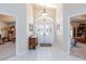 Bright foyer featuring tile flooring, double front doors with decorative glass, and high ceilings at 4690 Designer Way, Las Vegas, NV 89129