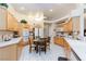 Eat-in kitchen with tile floors, wood cabinets and modern appliances at 4690 Designer Way, Las Vegas, NV 89129