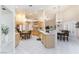 Bright eat-in kitchen features tile floors, wooden cabinets and modern appliances at 4690 Designer Way, Las Vegas, NV 89129