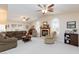 Inviting living room with neutral carpet, fireplace, vaulted ceiling, and ample natural light at 4690 Designer Way, Las Vegas, NV 89129
