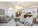 Open living area featuring neutral paint, carpeted floors, and view into the formal dining area at 4690 Designer Way, Las Vegas, NV 89129