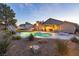 Lush backyard featuring a pool, spa, and covered patio area, ideal for enjoying the outdoors at 4690 Designer Way, Las Vegas, NV 89129