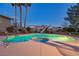 Inviting pool and spa with mature landscaping and a slide, perfect for outdoor relaxation and entertainment at 4690 Designer Way, Las Vegas, NV 89129
