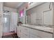 Bathroom with double sinks, granite countertops, and a walk-in shower at 4705 Blaise Ave # 101, North Las Vegas, NV 89084