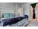 Cozy bedroom boasts a comfortable bed, soft lighting, and views of the adjoining room at 4705 Blaise Ave # 101, North Las Vegas, NV 89084